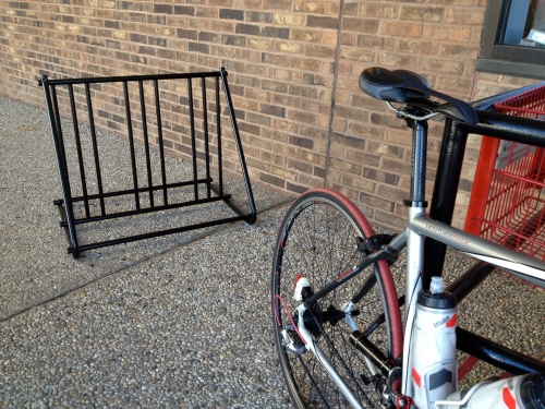I turn my red tire to TJ's bike rack like a baboon turns his red butt to his enemy